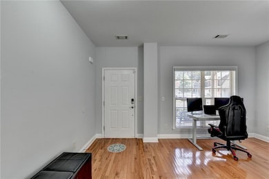Office space with light wood-style floors and baseboards