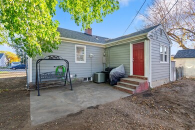 Rear view of property with a patio area, a chimney, a shingled roof, and entry steps