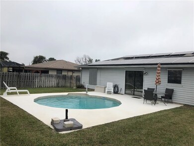 Large private fenced in yard with a beautiful pool