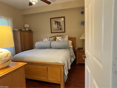 Bedroom with dark wood finished floors and a ceiling fan