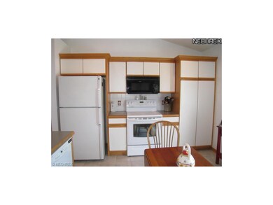 Spacious kitchen wtih ceramic tile floor.