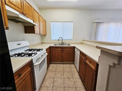 Kitchen with white appliances, under cabinet range
