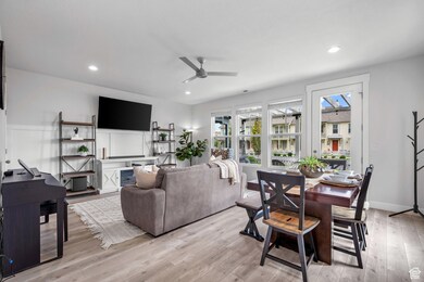 Living room with light wood-type flooring, ceiling fan, and recessed lighting