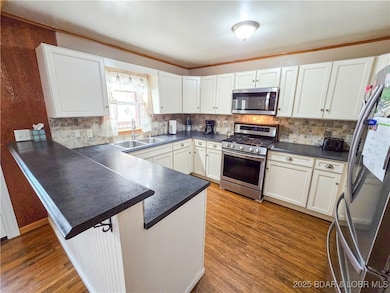 Kitchen to left with stainless appliance
