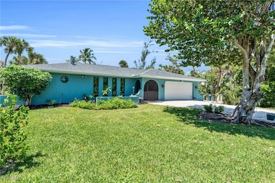Ranch-style house featuring a front yard and a garage