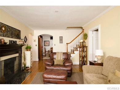 The living room has hardwood floors, crown molding