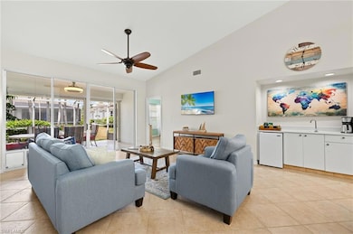 Living room featuring visible vents, a ceiling fan