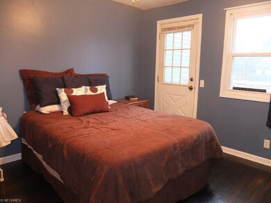 Bedroom 1 with wood flooring.