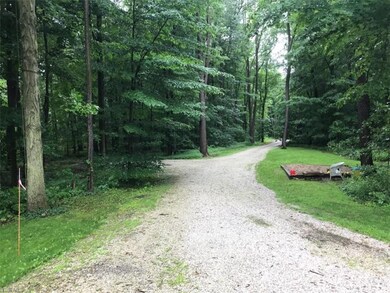 The 650 foot long meandering driveway takes you ba
