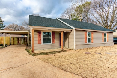 View of front of home with a shingled roof, brick 