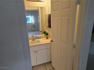 Bathroom featuring light tile patterned flooring and vanity