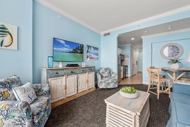 Living area with crown molding, recessed lighting, and baseboards