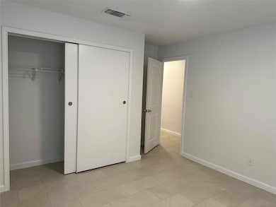 Unfurnished bedroom featuring a closet, baseboard