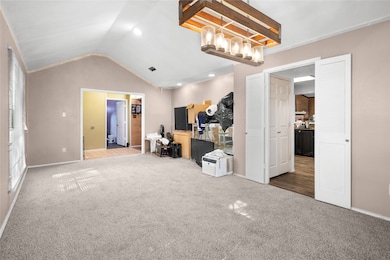 Carpeted bedroom featuring lofted ceiling and recessed lighting
