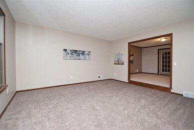 The living room benefits from new carpet and fresh