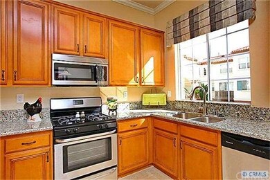 Granite counters, rich chestnut stained cabinets a