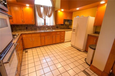 Large kitchen with handmade cabinets, recessed lig