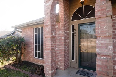 Doorway to property featuring brick siding
