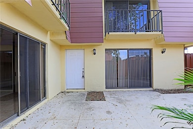 Doorway to property featuring a patio area and stucco siding