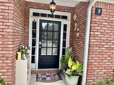 Doorway to property with brick siding