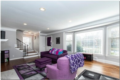 This Living Room benefits from plenty of natural light, and polished hardwood flooring