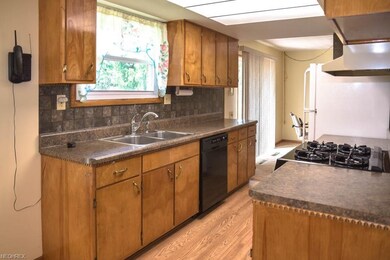 Fully applianced galley kitchen with a window abov