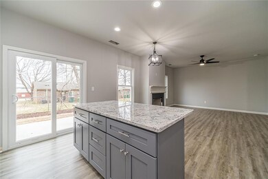 Kitchen island can seat a few people on the other side for a quick meal. Just steps outside to be able to grill your favorite meal.