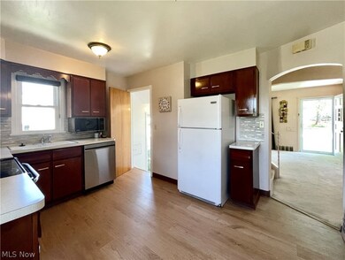 Kitchen featuring tasteful backsplash, refrigerator, and stainless steel dishwasher