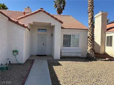 Property entrance featuring stucco siding, a tile