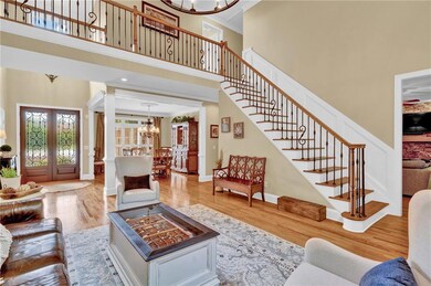 Grand entry with dramatic staircase, iron baluster