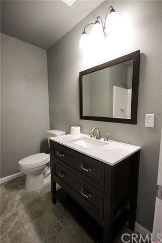 Stylish guest bath with new vanity, flooring and f