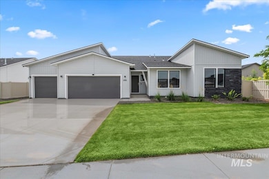 View of front of house with an attached garage, concrete driveway, board and batten siding, a shingled roof, and stone siding