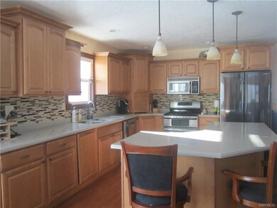 Awesome kitchen with Maple cabinets, glass tile ba