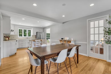 Open flow between kitchen and dining room (and see glass pocket door to family room).