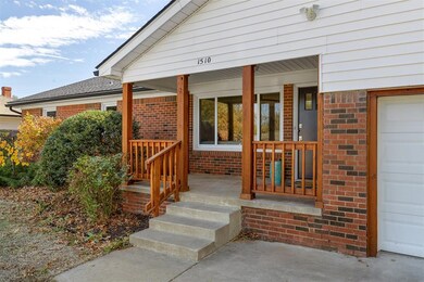 Entrance to property featuring a porch and a garag