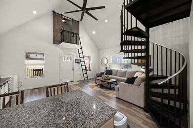 Living room featuring high vaulted ceiling, basebo
