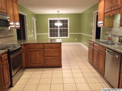 The kitchen has granite countertops, new stainless steel oven range, microwave, and dishwasher.