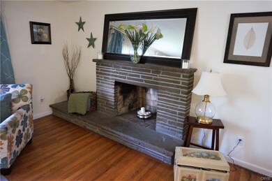 The woodburning fireplace is the focal point of th
