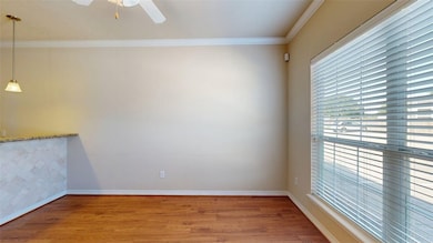 Empty room featuring wood finished floors, ornamen