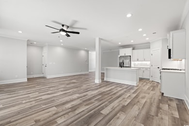 Unfurnished living room featuring light hardwood /