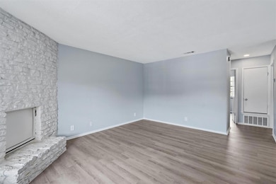 Unfurnished living room with baseboards, a large 