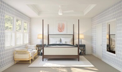 Primary suite with decorative feature wall and tray ceiling with crown moulding