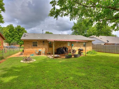 Back of house featuring brick siding, a patio area, and a fenced backyard