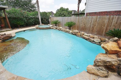 HEATED POOL WITH RAISED SPA , TANNING DECK,AND COVERED PATIO