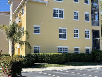 View of building exterior with uncovered parking