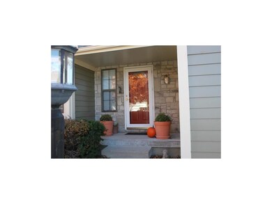Cheery Red front door and inviting front porch.