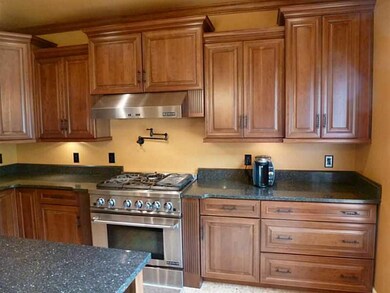 Kitchen. Stainless steel JennAir gas stove,, hood 