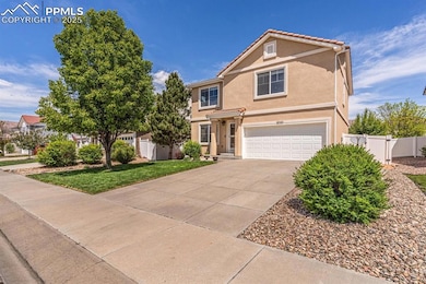 Traditional-style house with an attached garage, stucco siding, driveway, and a tiled roof