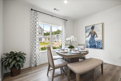 Dining space featuring wood finished floors and baseboards