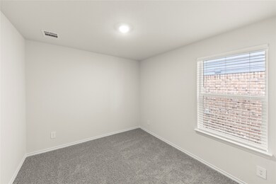 Unfurnished room with baseboards and carpet